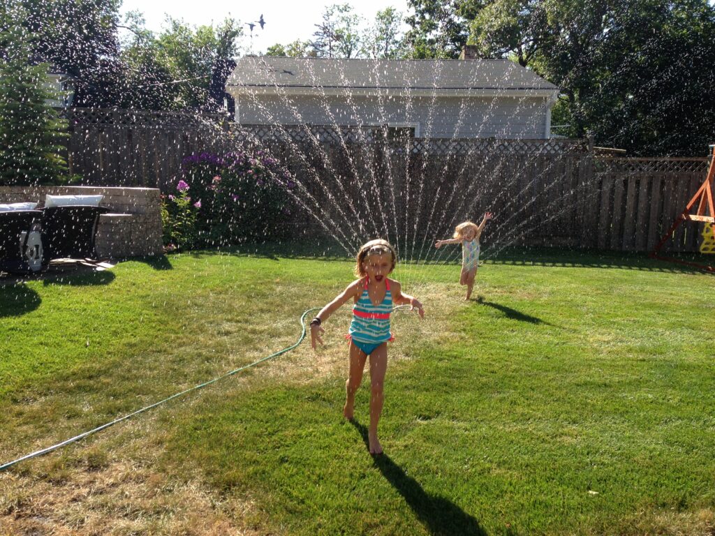 Kids playing in a sprinkler