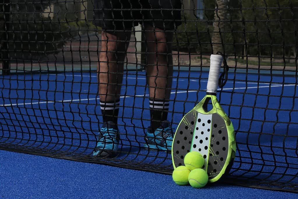 padel racket and balls on court