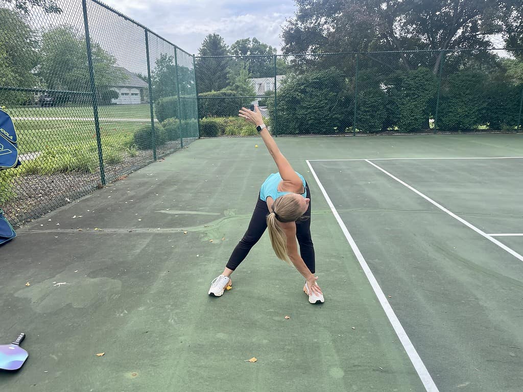 woman stretching for pickleball