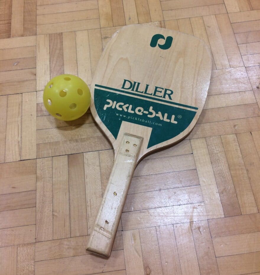 old school pickleball paddle and ball